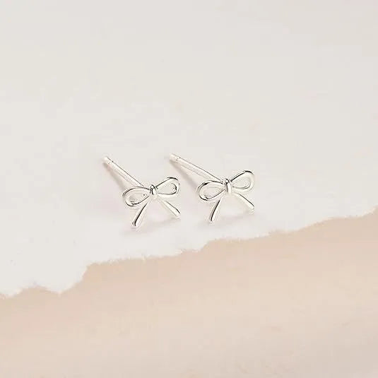 Women's gold bow cross stud earrings in zinc alloy with geometric design