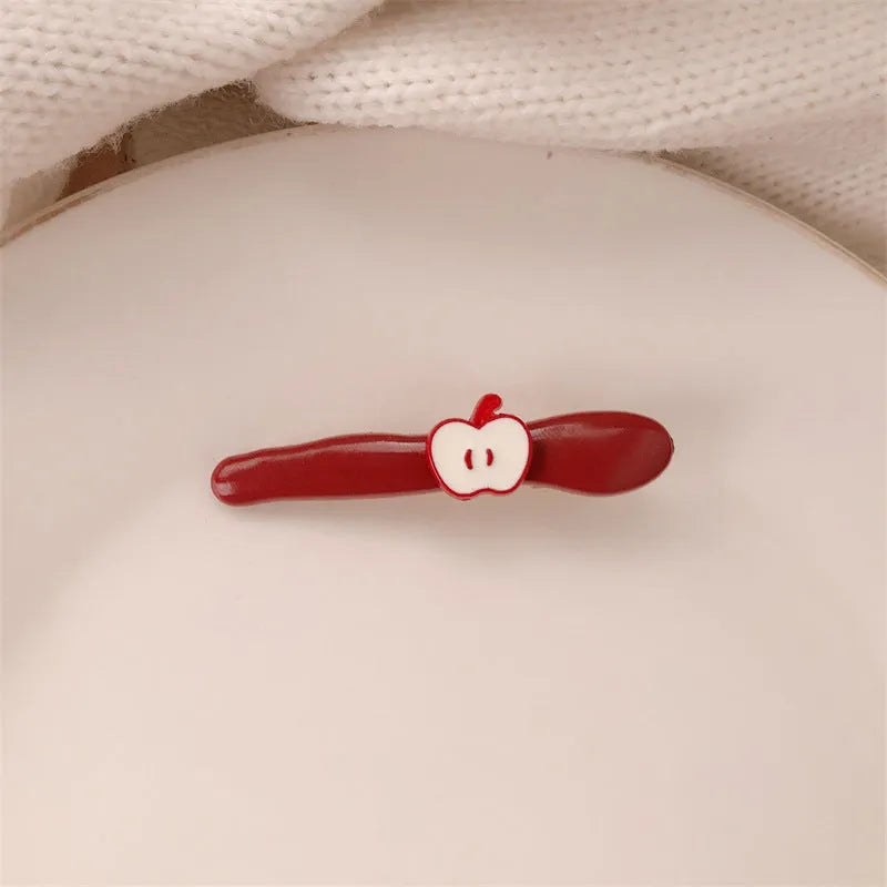 Red love heart-shaped hair barrette clip with retro white dots on a willow leaf-shaped base.