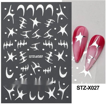 Assortment of black and silver nail sticker designs including cartoon and French tip patterns on a plastic sheet.