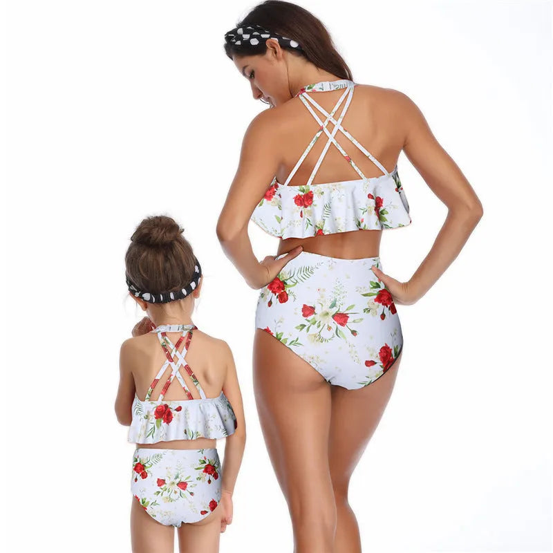 Nylon one-piece swimsuit with chest pad, available in flower, orange, and red, adult and child sizes.