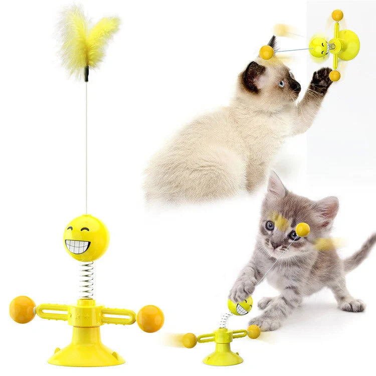 Cat playing with rotating windmill toy featuring luminous balls and suction base