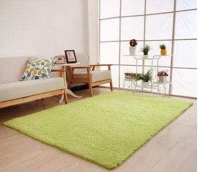 Solid colour plush rectangle area rug with soft texture on a wooden floor.