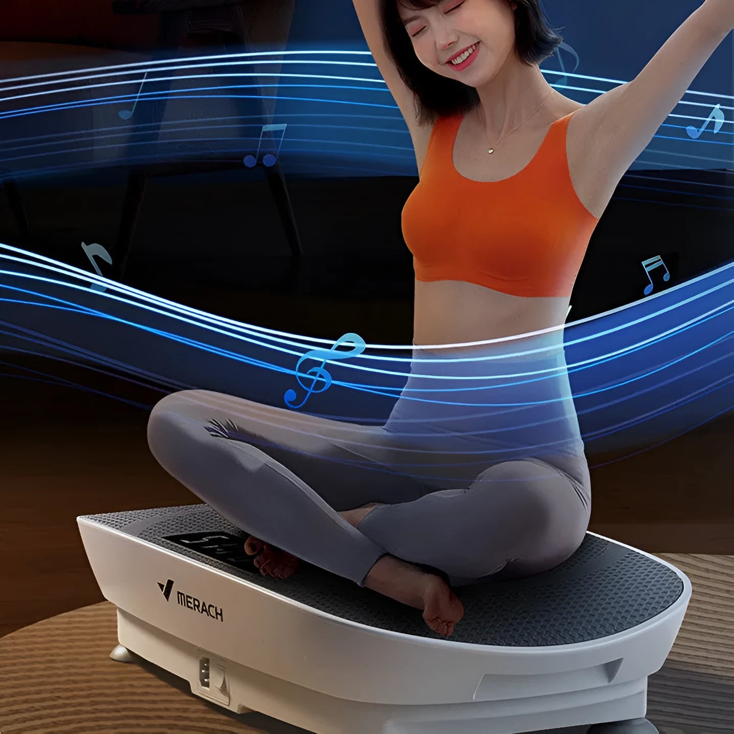 Grey portable vibration plate on a wooden floor, showing its slim 16cm profile and textured platform surface.