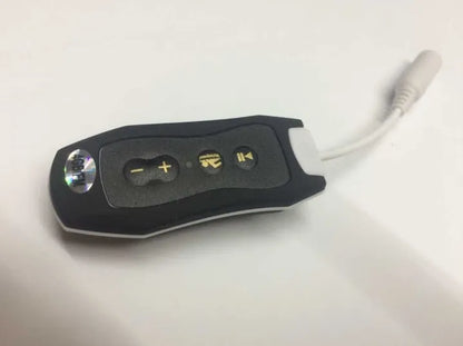 Compact black Bluetooth MP3 headset with clip, shown next to USB charging cable.