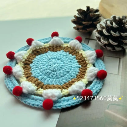 Finished wool crochet coaster bag with cake design measuring 9cm diameter