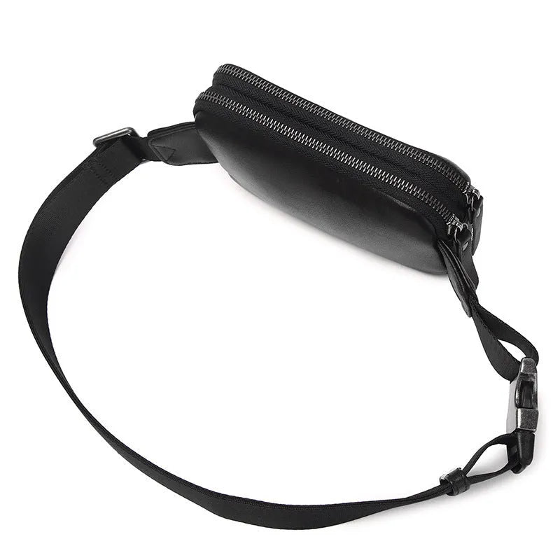 Men's small leather crossbody bag in black showing compact dimensions and crossbody strap