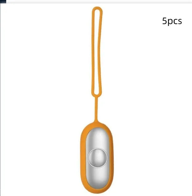 Hand-held micro-current sleep aid device in grey, green, or orange with round button and USB charging port