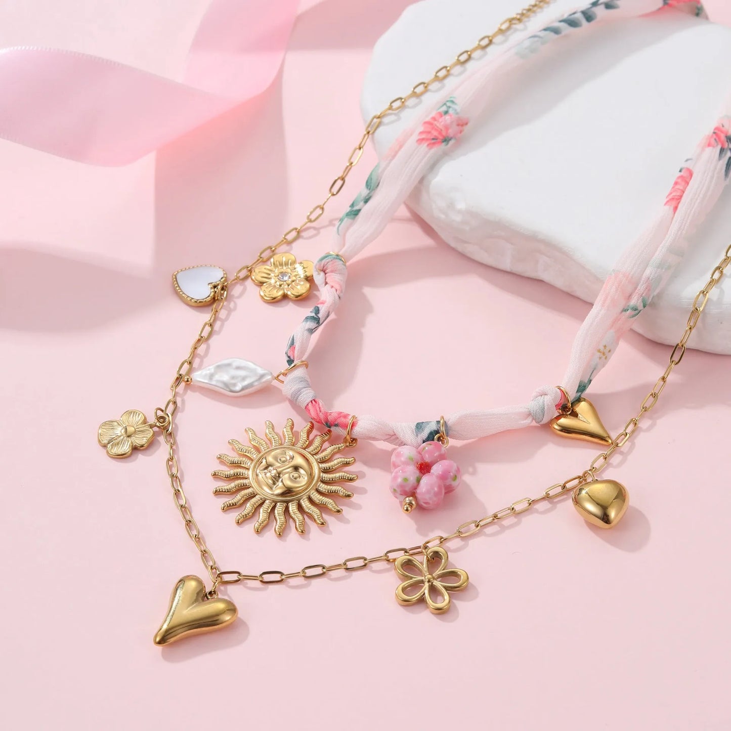 Stainless steel necklace with a geometric sun pendant on an adjustable chain.