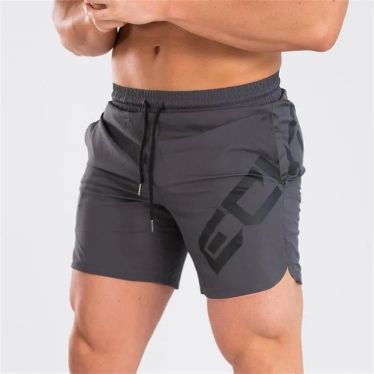 Man wearing black knee-length nylon training shorts with an elastic mid waist.