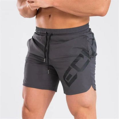Man wearing black knee-length nylon training shorts with an elastic mid waist.