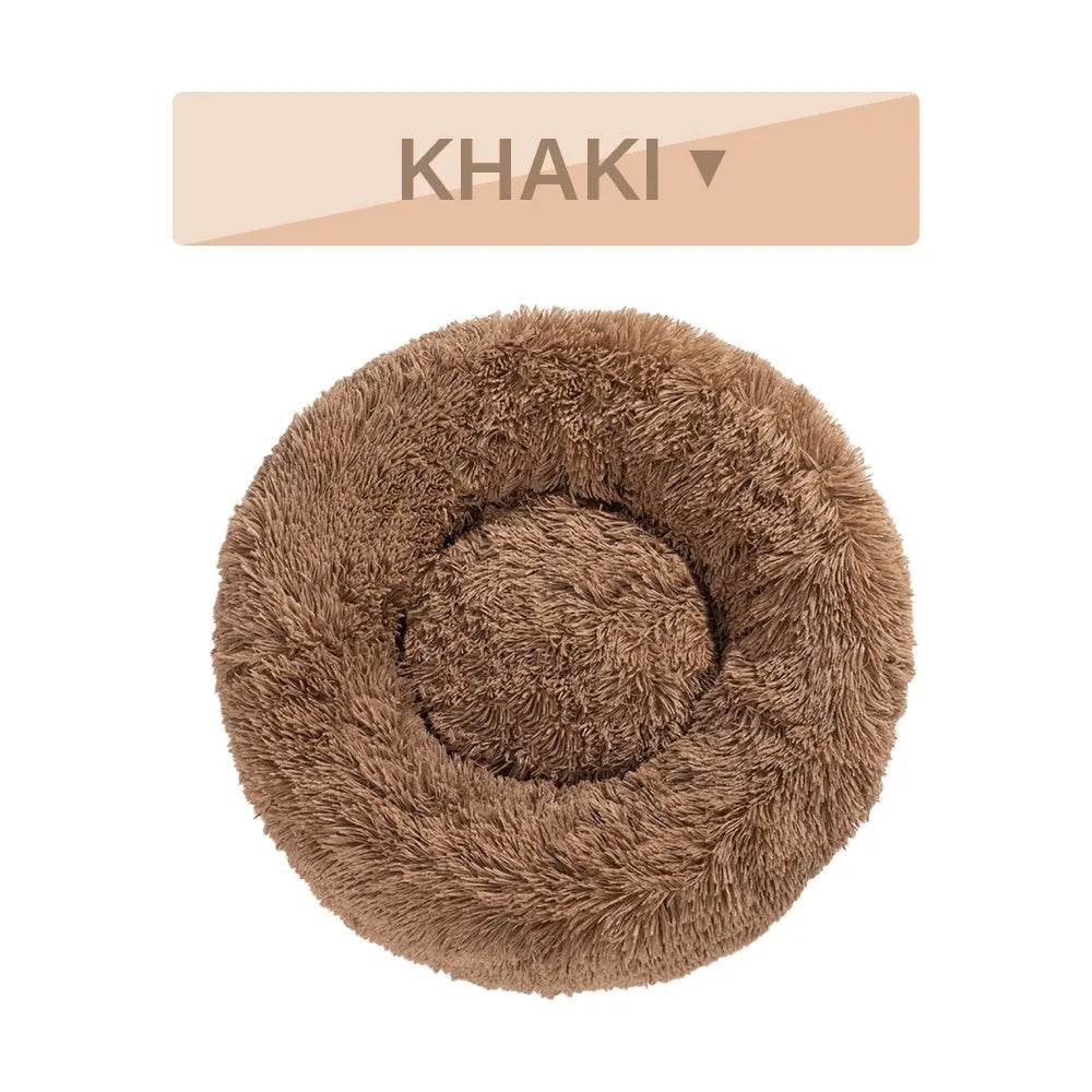 Fluffy donut-shaped pet bed with raised bolster edge in long plush material
