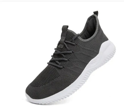 Men's black and white breathable mesh sneakers with round toe and lace-up closure on a grey background.