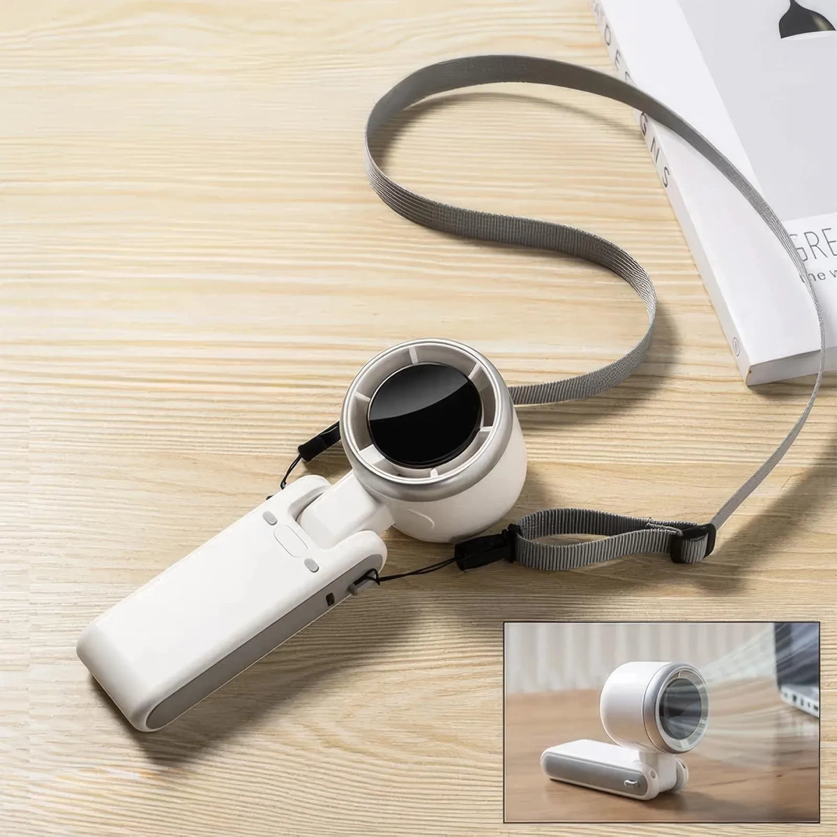 Portable folding mini fan showing adjustable head and compact plastic housing with USB Type-C charging port