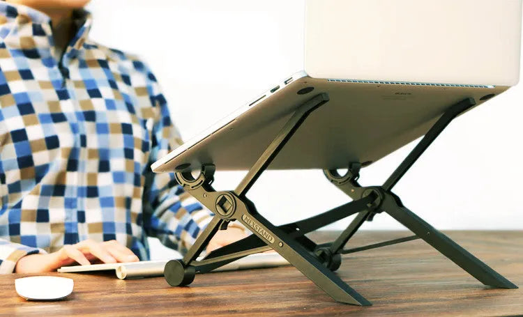 Black folding laptop stand made of reinforced nylon, shown supporting a silver laptop at an angle.