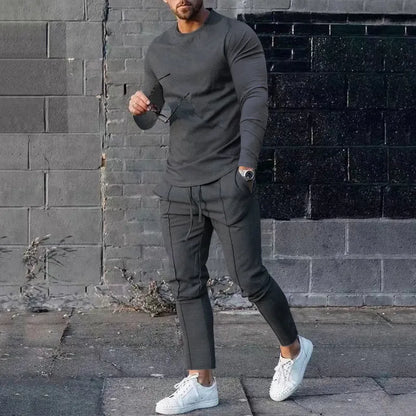 Men's solid colour two-piece lounge suit with long sleeve T-shirt and trousers in light grey.