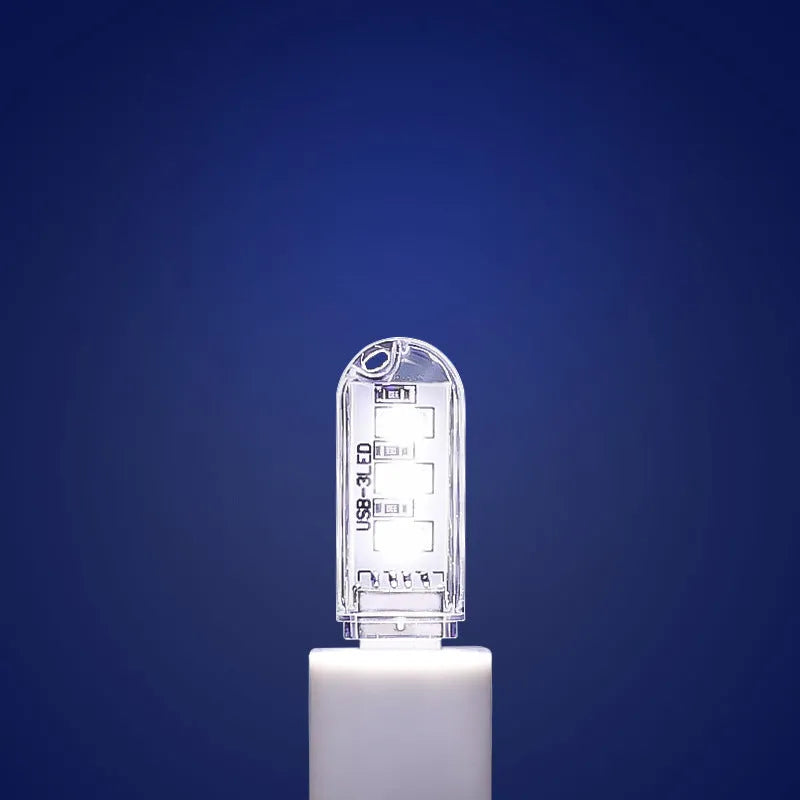 Small white USB LED baby night light showing warm and white light colour options.
