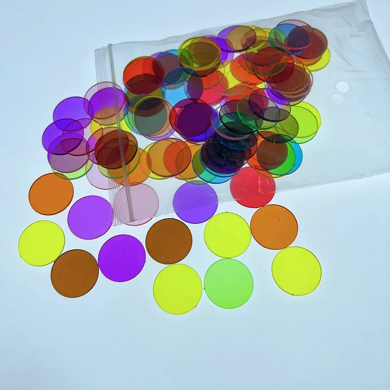 Bag of 100 plastic counting chips in 19mm or 25mm size, solid colour or transparent, for children aged 4 to 6