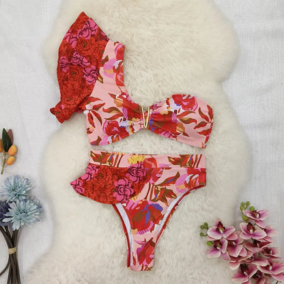 Women's one-shoulder ruffled high-waist bikini with pink background and red flower pattern