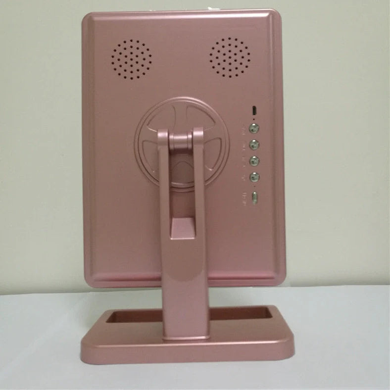 Pink touch screen makeup mirror with LED lights and Bluetooth speaker showing 10X magnification section