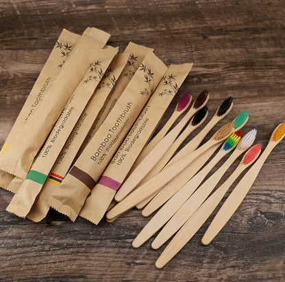 10 natural bamboo toothbrushes with charcoal bristles in six colours showing 17.5cm length