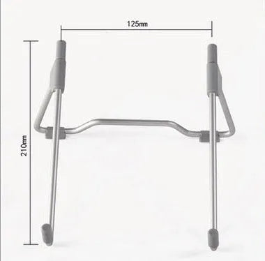 Grey aluminium and plastic adjustable stand holding a mobile phone on a wooden desk.