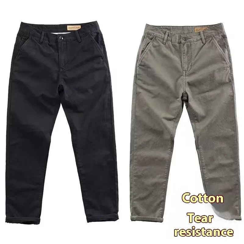 Man wearing slim fit grey micro elastic washed trousers with a straight leg cut for a business casual look.