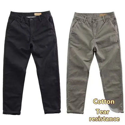 Man wearing slim fit grey micro elastic washed trousers with a straight leg cut for a business casual look.