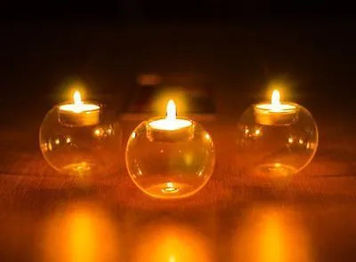 Handmade hollow round glass candle holder in European style on a table.