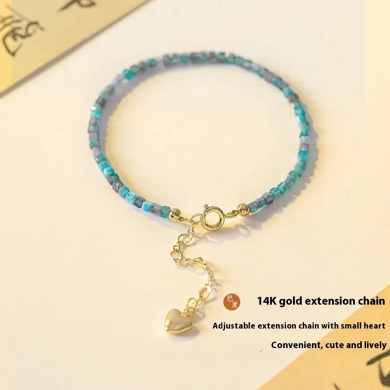 Women's blue apatite crystal bracelet with diamond-cut stones on wrist