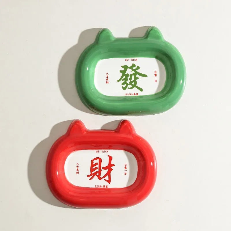 Four ceramic animal-themed pet bowls with frog, panda, pig, and fortune cat designs and silicone non-slip bases
