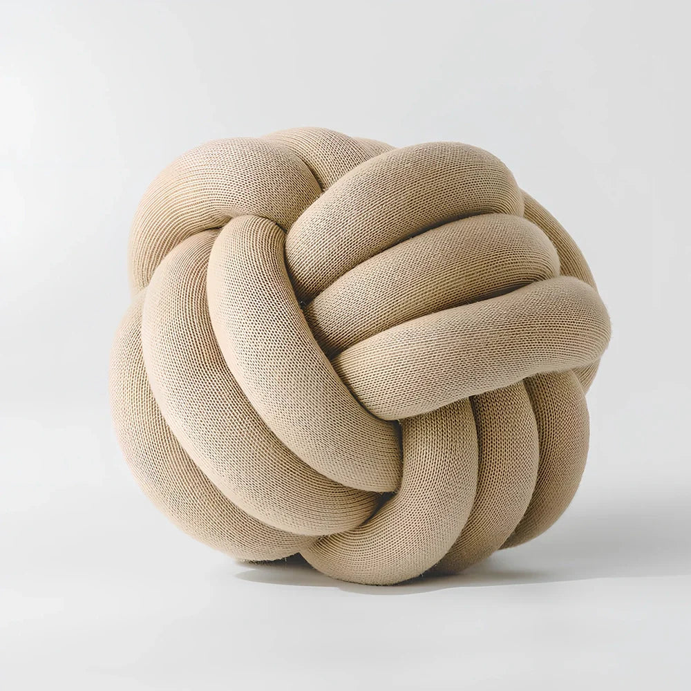 Knotted lumbar pillow with memory foam fill showing adjustable height feature and polyester cover