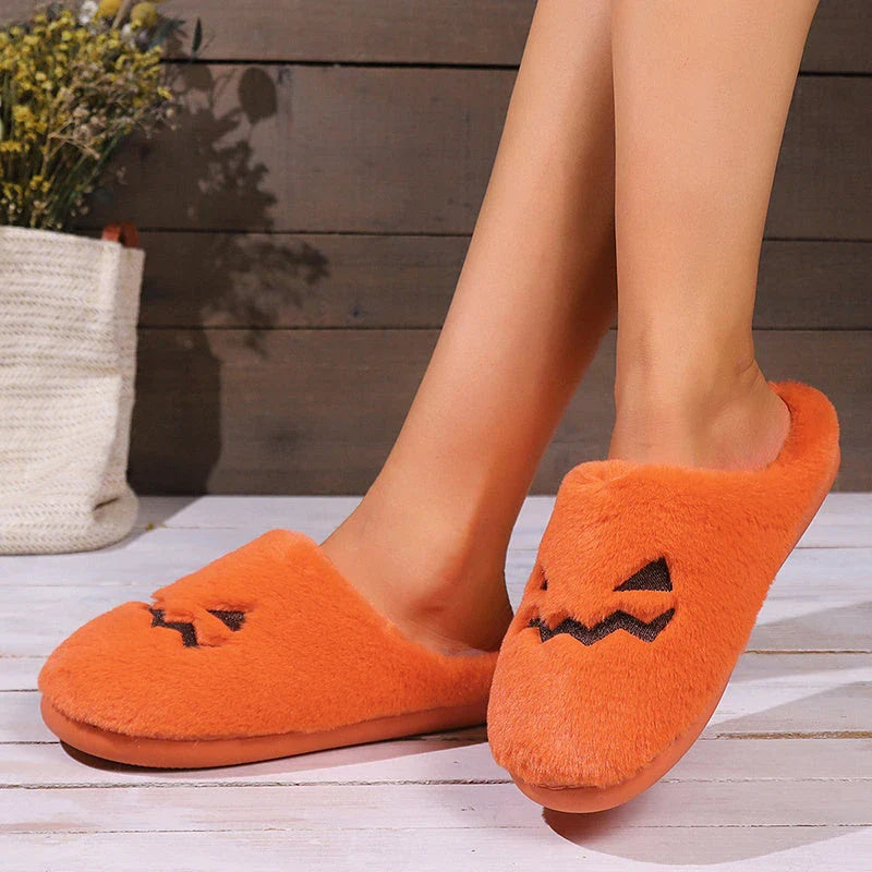 Cozy pumpkin-shaped slippers in orange color with plush fabric and non-slip sole for comfortable indoor wear