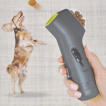 Grey-coloured pet treat catapult launcher for dogs and cats on a plain background.