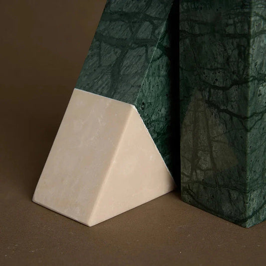 A pair of natural green marble bookends with a retro travertine finish, standing upright and supporting books on a shelf.