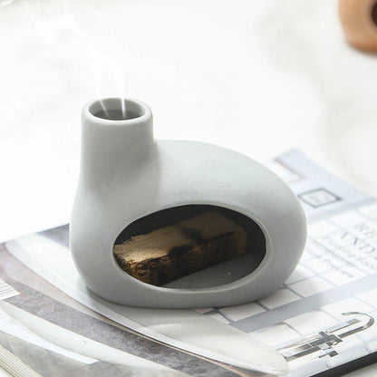 Elegant and modern ceramic incense burner with Palo Santo wood holder, designed to enhance your living space with a calming aroma.