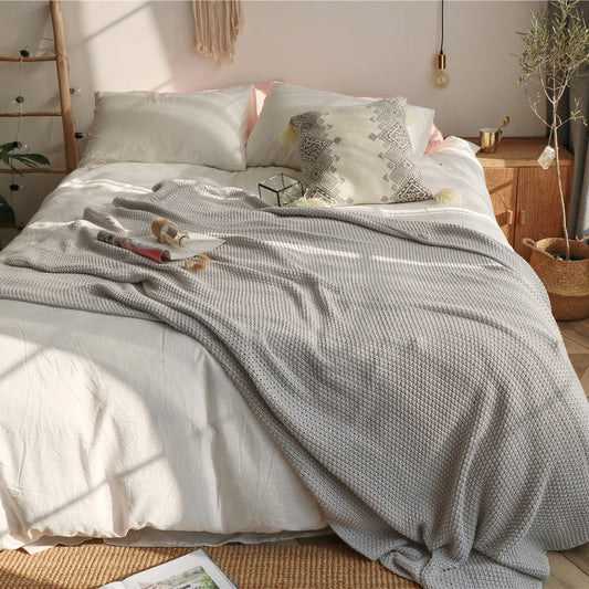 Cosy oversized moss stitch knitted blanket in a variety of elegant colours, perfect for adding comfort and style to your living space.
