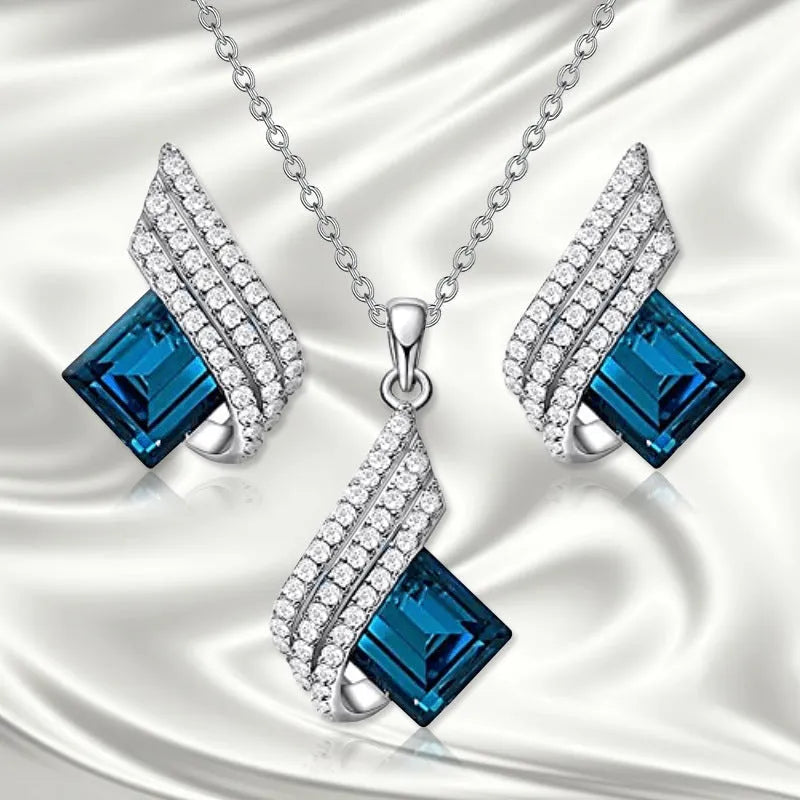 Necklace and earring set with alloy pendant and cross chain in two colour options.