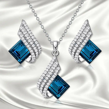 Necklace and earring set with alloy pendant and cross chain in two colour options.