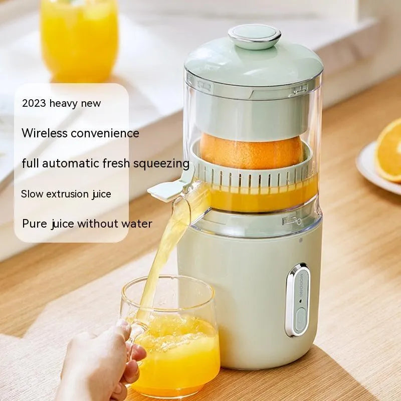 Fresh green portable USB electric juicer and blender for oranges and vegetables on a kitchen counter.