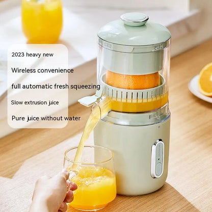 Fresh green portable USB electric juicer and blender for oranges and vegetables on a kitchen counter.