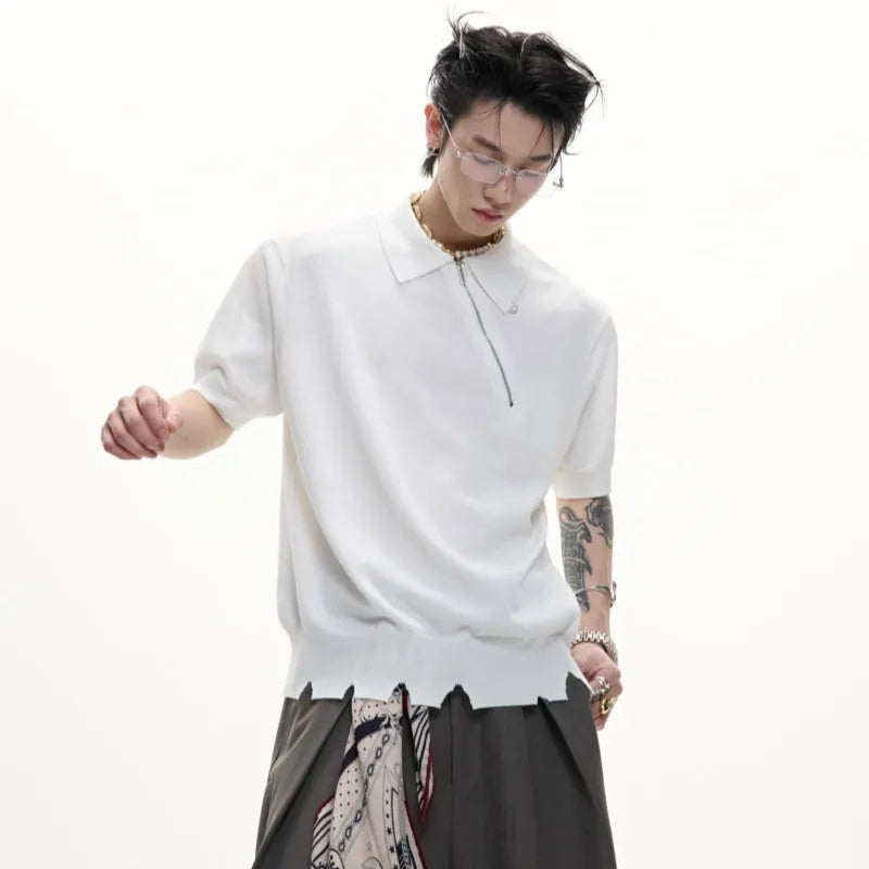 Man wearing a slim-fit black polo shirt with an oblique diagonal zipper and short sleeves.