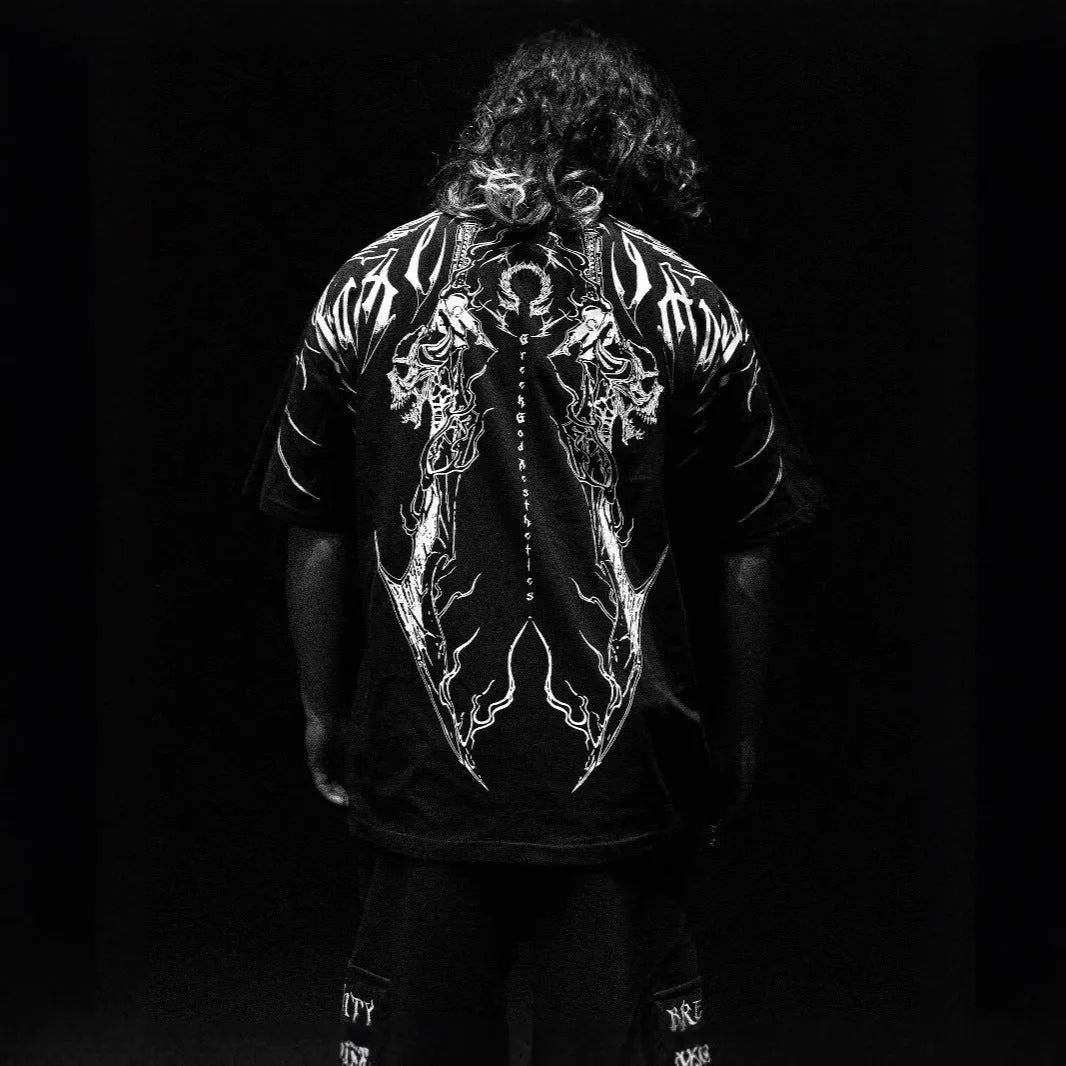 Man wearing a dark loose-fitting plus-size cotton short-sleeved T-shirt with gilding details.