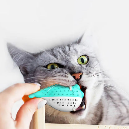 Mint Toys blue silicone fish-shaped cat chew toy on a wooden floor.