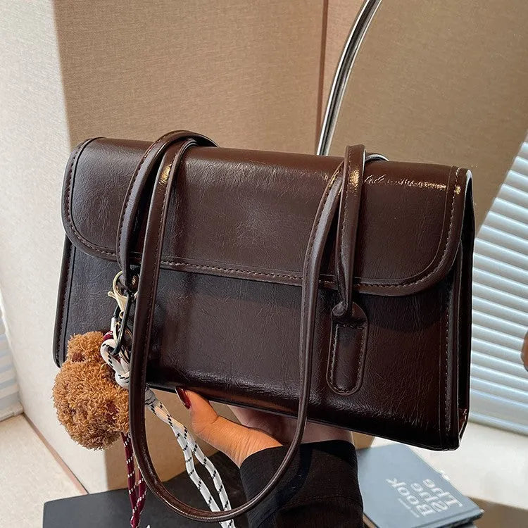 Brown women's square shoulder bag with double straps and pendant accessory