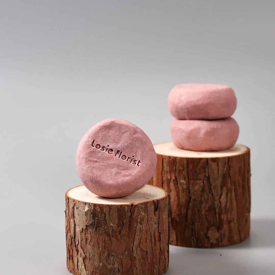 Pink round handmade rosewood grinding soap with roselle and tangerine peel ingredients