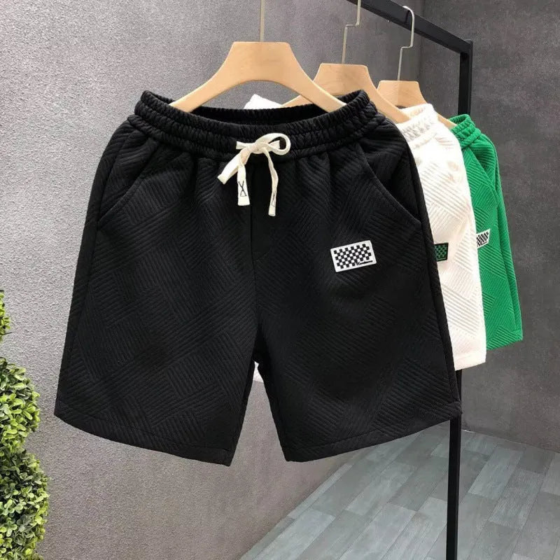 Men's solid colour polyester sports shorts with micro-elasticity, shown in black.