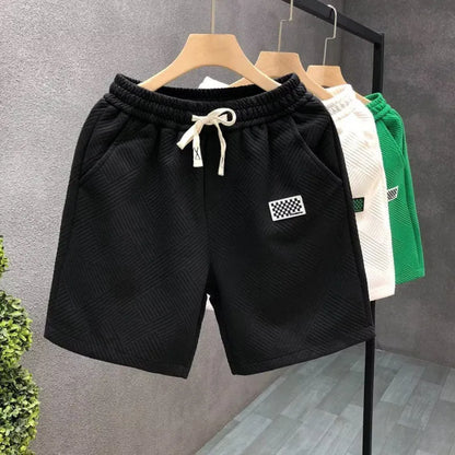 Men's solid colour polyester sports shorts with micro-elasticity, shown in black.