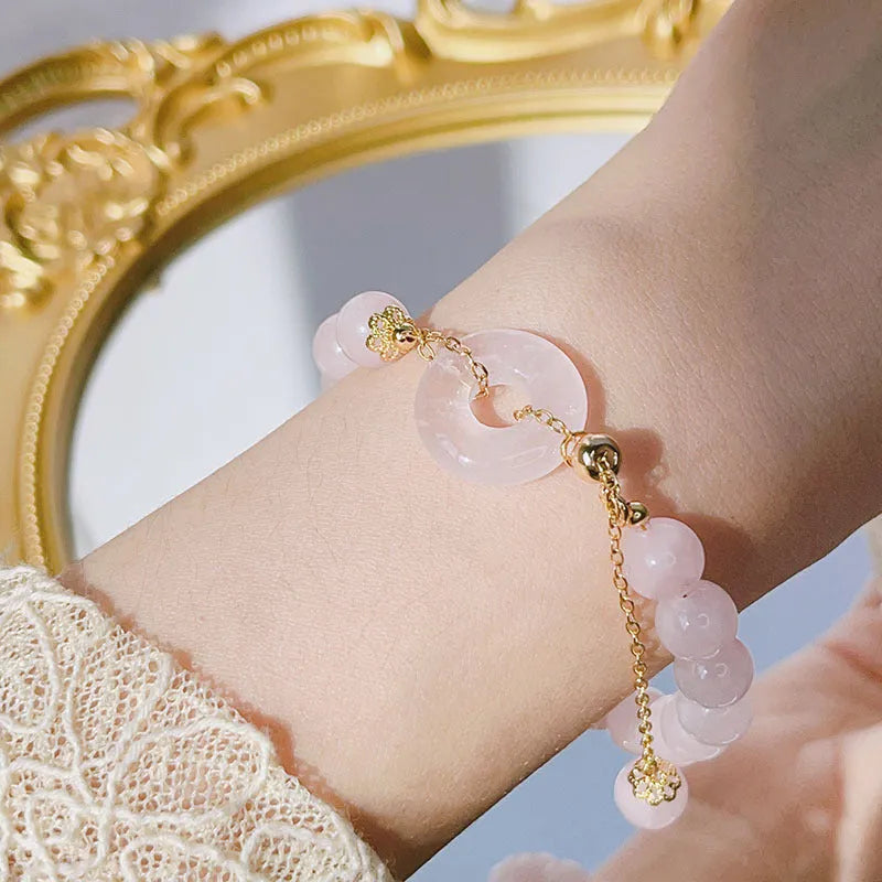 Women's crystal peace buckle bracelet with simple design and adjustable fit, featuring pink crystal accents and peace buckle closure for everyday wear, fashion jewellery accessory with secure fastening