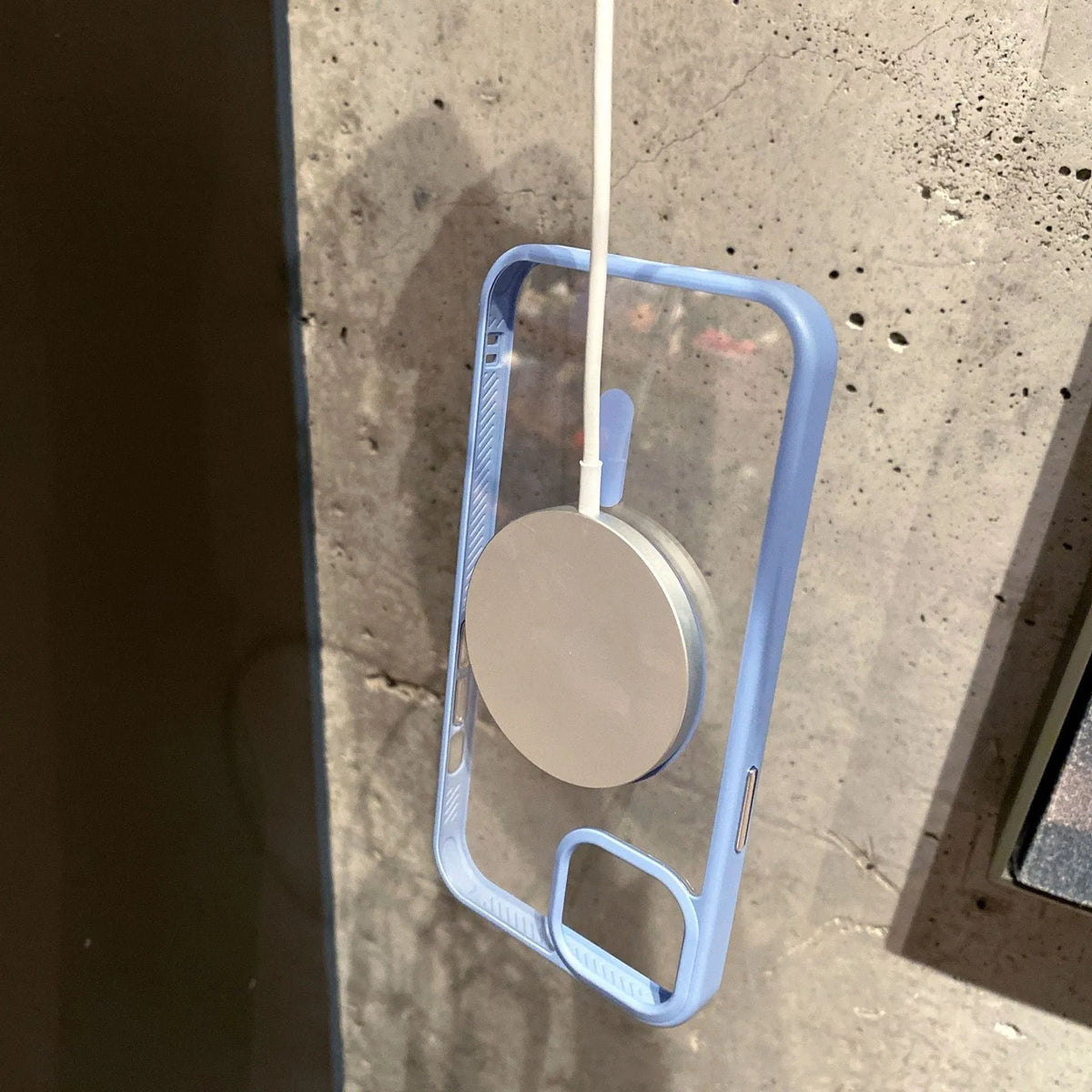 Clear acrylic MagSafe phone case for iPhone showing magnetic ring, displayed in pink, blue, white, black, and navy blue colour options.