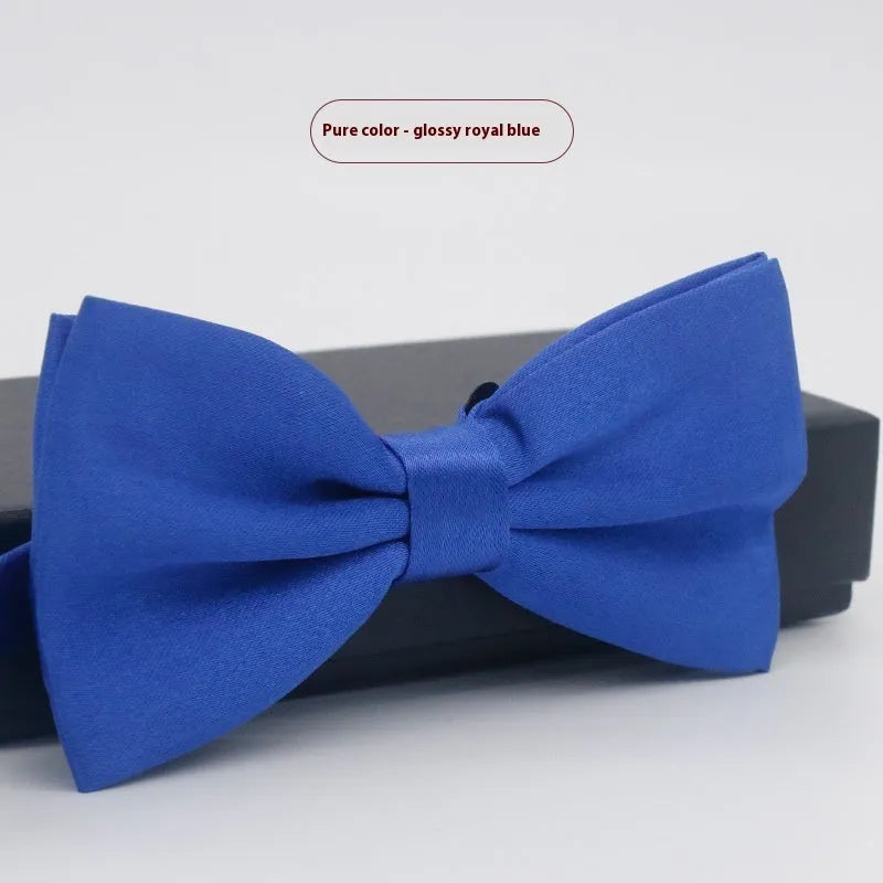 A solid colour pre-tied bow tie with an adjustable neck strap, shown in a classic flat head shape.
